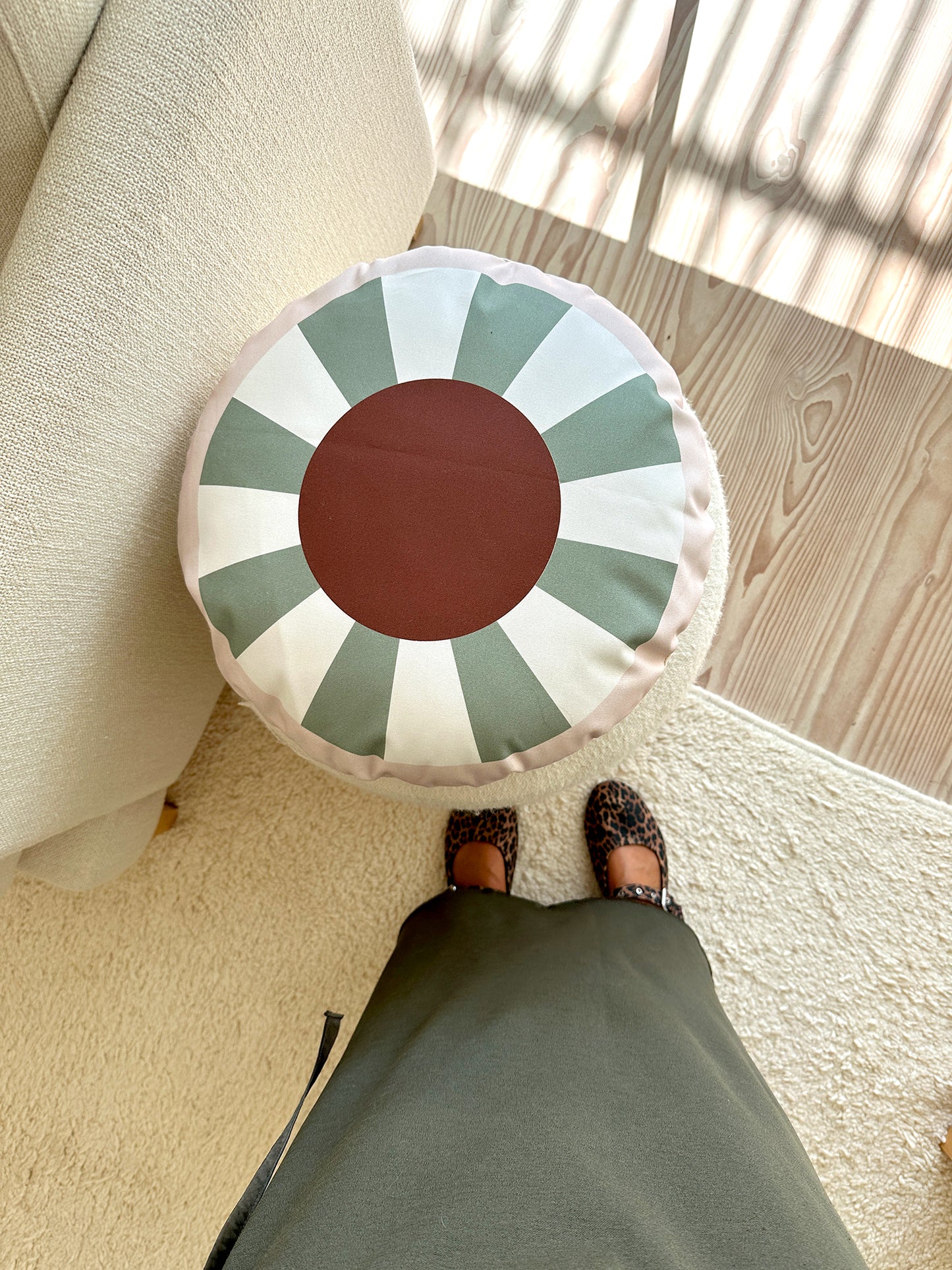 TOM round decorative cushion in green and brown, with vibrant geometric patterns, made from organic cotton, eco-friendly, perfect for kids' rooms and modern home decor.