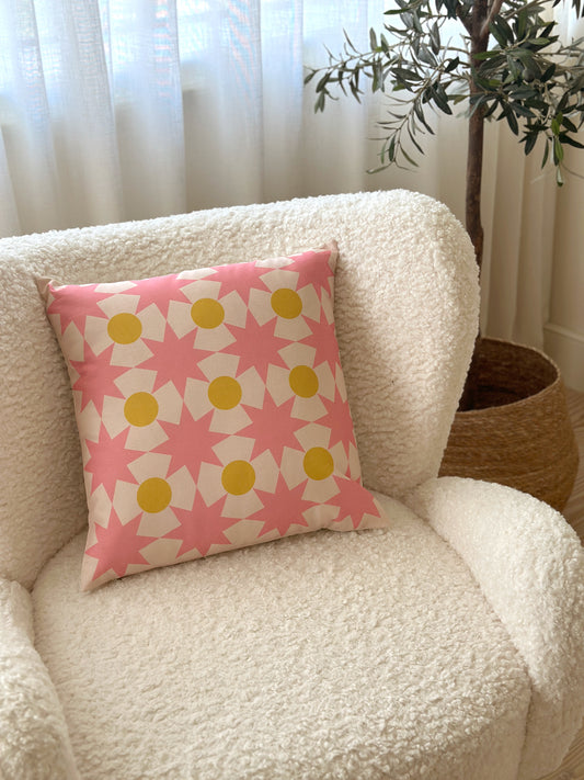 Star Point geometric decorative cushion in pink and yellow, made from organic cotton, eco-friendly, perfect for kids' rooms and modern home decor.